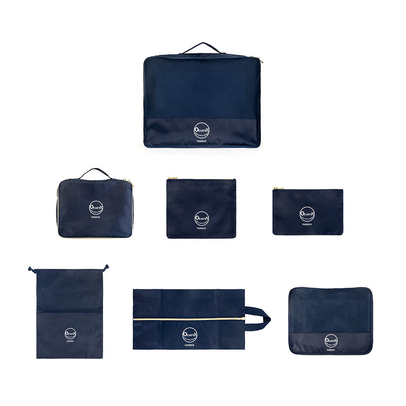 Navy 7‑piece travel organizer set, overhead layout with all seven bags