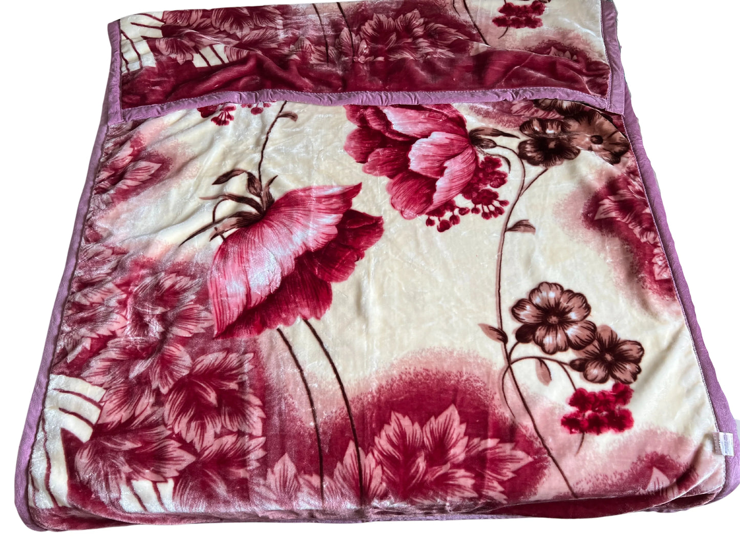 SilkenWarmth Raschel blanket, large floral motif, draped over an accent chair